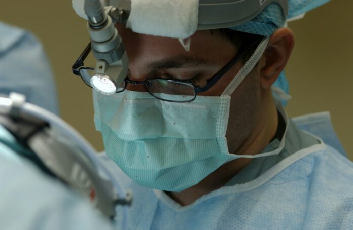 Photo by National Cancer Institute man in blue and white collared shirt wearing green face mask