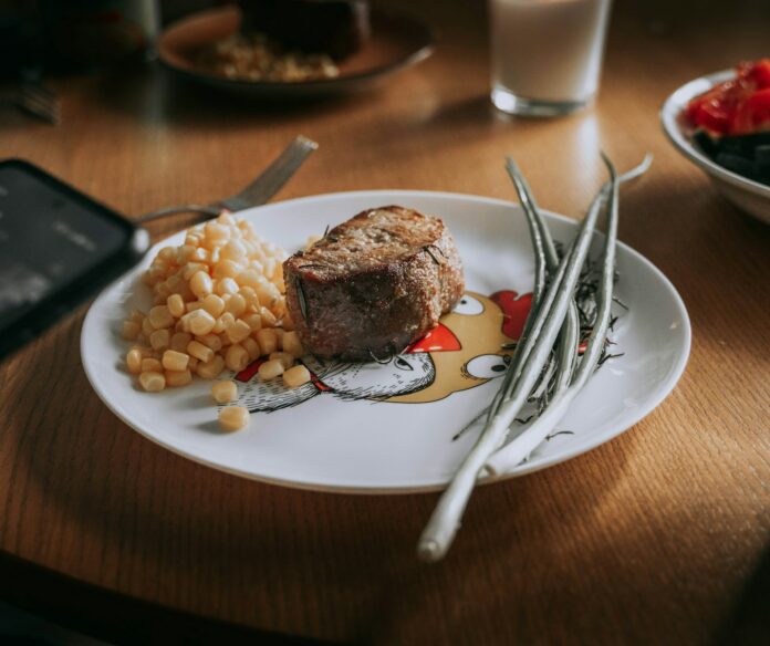 Photo by Artem Balashevsky A plate of food on a wooden table