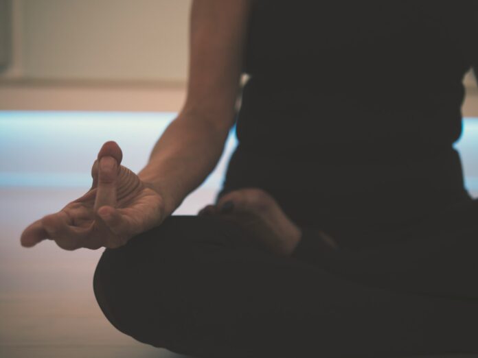 Photo by JD Mason person doing yoga on floor