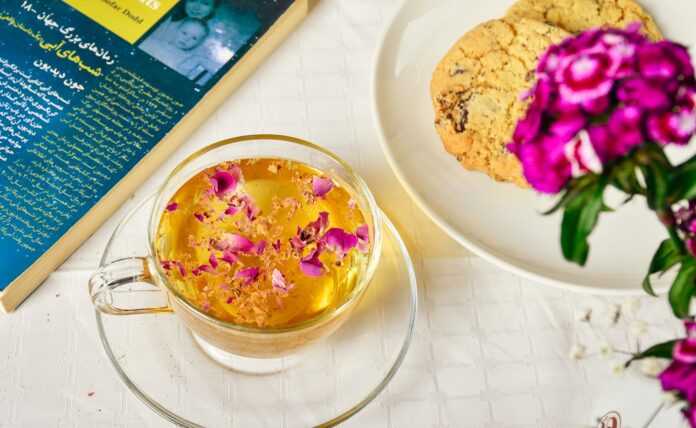 a bowl of food next to a flower