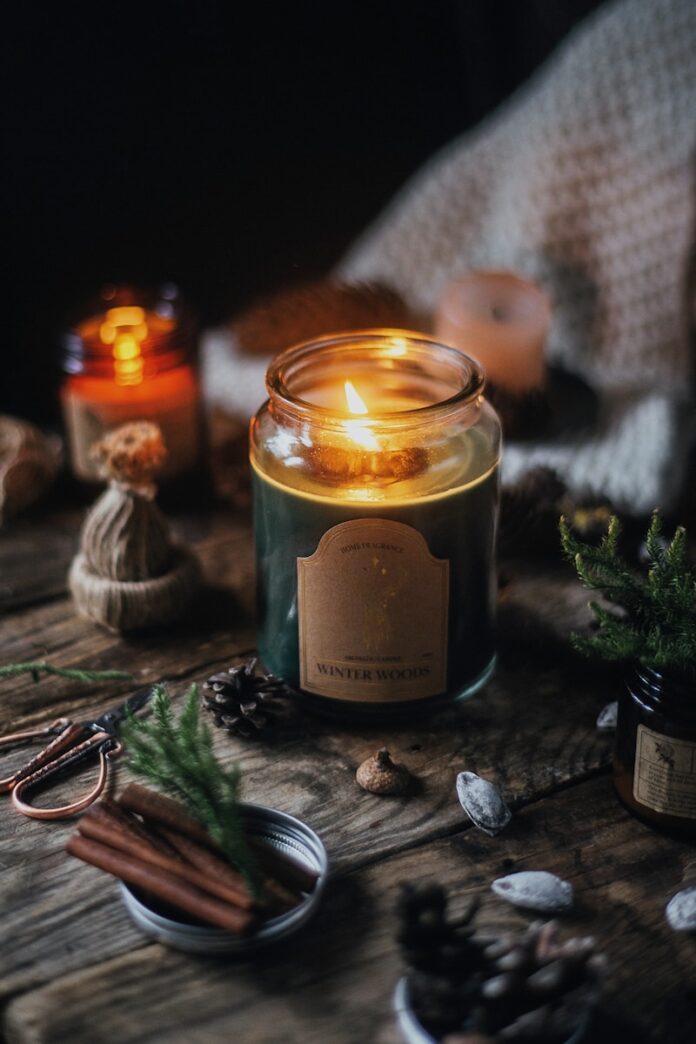 Photo by Kate Laine a candle in a glass jar