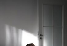 “마음 챙김이 가져오는 변화: 일상 속 스트레스 해소 실천법” a woman sitting on the floor in front of a door